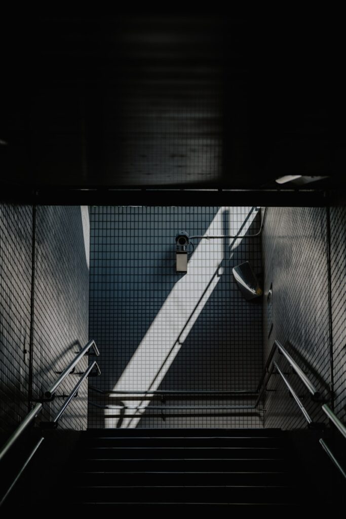 a stair case with a railing and a light at the top