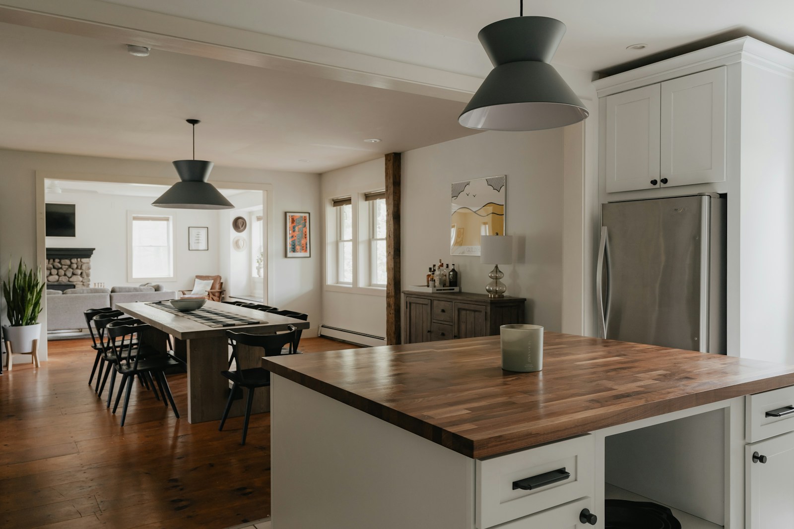a kitchen with a table and a refrigerator