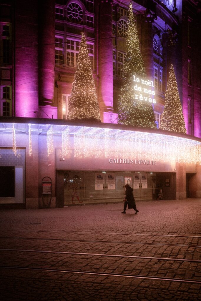 a person walking down a street in front of a building